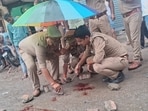 Police inspect the crime scene in Meerut’s busy Civil Lines area (HT Photo)