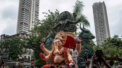 Devotees carry an idol of the elephant-headed Hindu deity 'Ganesha' ahead of the Ganesh Chaturthi festival in Mumbai on July 20, 2025. (Photo by Punit PARANJPE / AFP) (AFP) Devotees carry an idol of the elephant-headed Hindu deity 'Ganesha' ahead of the Ganesh Chaturthi festival in Mumbai on July 20, 2025. (Photo by Punit PARANJPE / AFP) (AFP)