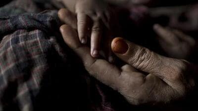 IA Rohingya woman holds her baby boy's hand at a refugee camp in Bangladesh. (AP FILE/REPRESENTATIVE IMAGE) IA Rohingya woman holds her baby boy's hand at a refugee camp in Bangladesh. (AP FILE/REPRESENTATIVE IMAGE)