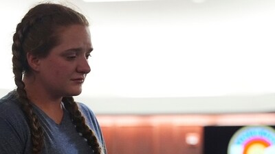 Miriam Meservy returns to her seat after making a statement after her father, dentist James Craig, had a verdict rendered in his murder trial in the district court in Arapahoe County, Colorado. (AP)