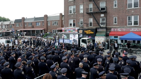 Police officers gather in front of an LED screen lit up in honor of the NYPD officer Didarul Islam during his funeral. REUTERS/Jeenah Moon(REUTERS)