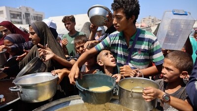 A public food distribution point serving lentil soup to hungry, malnourished children. With scarce supplies, treating malnourished Palestinian children in war-torn Gaza is growing harder, say doctors and aid groups. (Omar Al-Qattaa/AFP)