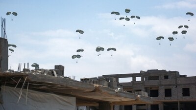 Aid parcels fall from airdrops over Jabalia, Gaza, as a US envoy visits a food centre amid reports of Israeli forces killing hundreds awaiting relief.&nbsp; (Bashar Taleb/AFP)