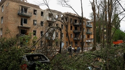 Rescuers work in front of an apartment building hit during Russian missile and drone strikes, amid Russia’s attack on Ukraine, in Kyiv, Ukraine. (REUTERS)