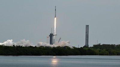 Flames and smoke billowed from the base as the SpaceX Falcon 9 rocket soared skyward, transporting four astronauts. (Photo by Chandan Khanna / AFP) (AFP) Flames and smoke billowed from the base as the SpaceX Falcon 9 rocket soared skyward, transporting four astronauts. (Photo by Chandan Khanna / AFP) (AFP)