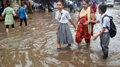 Commuters and school children were seen wading on waterlogged roads after heavy rainfall, in parts of Delhi on Thursday. (Mohan Lal/ANI) Commuters and school children were seen wading on waterlogged roads after heavy rainfall, in parts of Delhi on Thursday. (Mohan Lal/ANI)