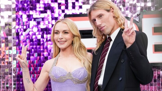 Lindsay Lohan in custom Ludovic de Saint Sernin, posing alongside the designer himself. Her embellished ensemble pays homage to her role as Anna Coleman from the original movie, who was seen wearing a similar looking gown to Tess Coleman's wedding in the final scene of the movie.(Scott A Garfitt/AP)