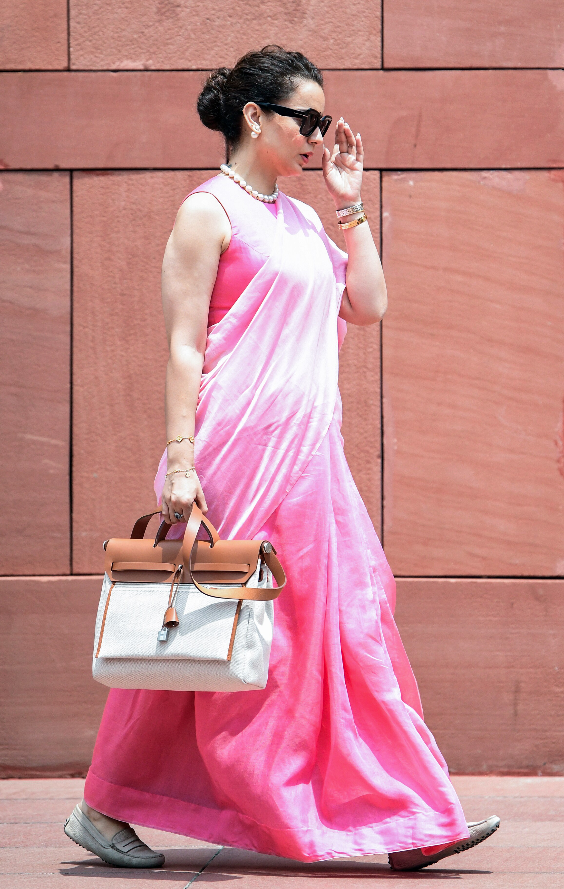 Power dressing, pink edition! The Parliamentary diva arrived in a sophisticated plain pink saree, paired with a pearl necklace and earrings, to attend a Lok Sabha session. (Shrikant Singh/ANI) Power dressing, pink edition! The Parliamentary diva arrived in a sophisticated plain pink saree, paired with a pearl necklace and earrings, to attend a Lok Sabha session. (Shrikant Singh/ANI)