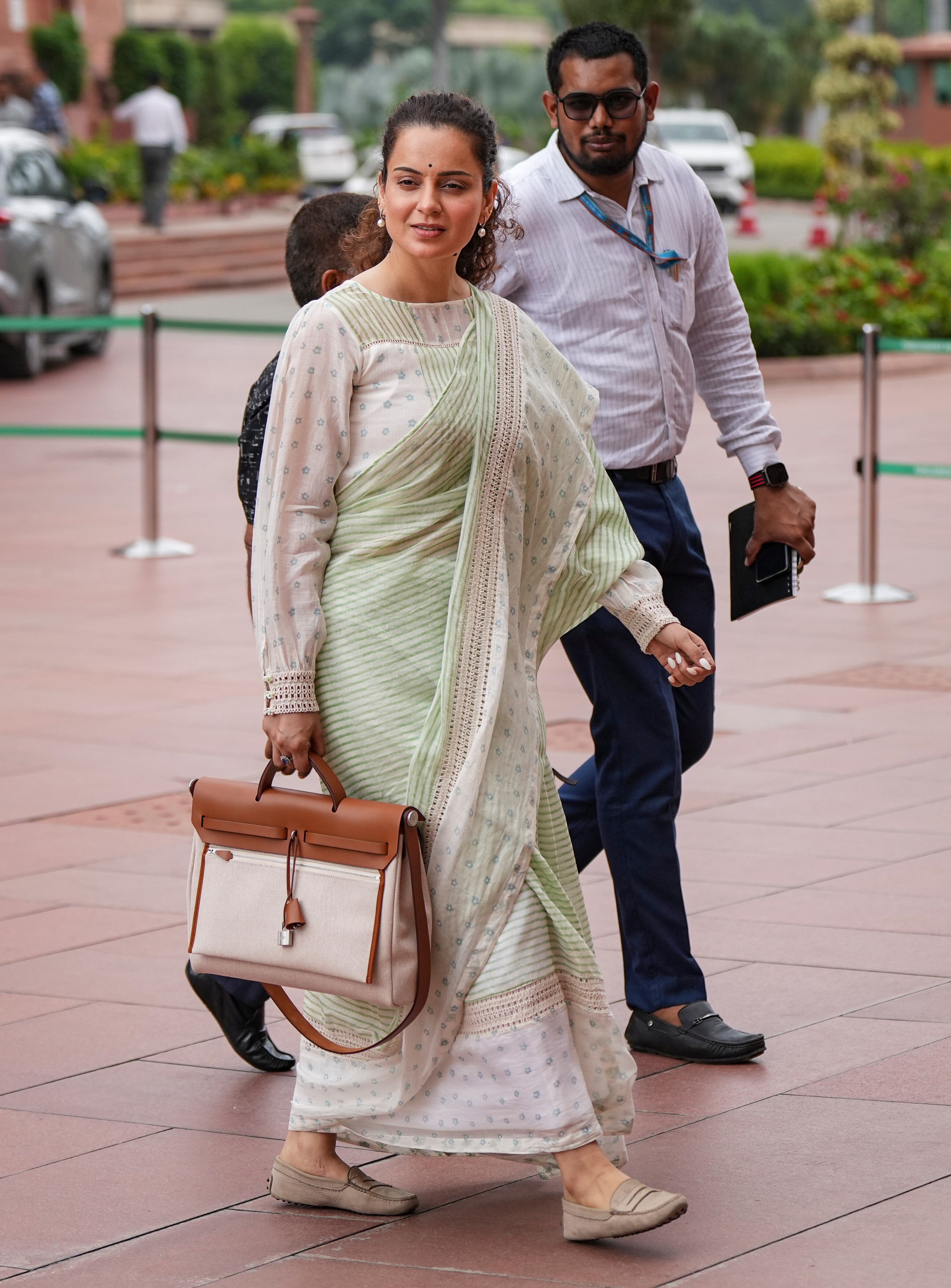 Minimalist elegance that is graceful, grounded and perfectly Parliament-ready! The BJP MP opted for an unconventional piece - a delicate pastel green and ivory striped handloom-inspired saree paired with a loose-fitted, full sleeves blouse. (Arun Sharma/PTI) Minimalist elegance that is graceful, grounded and perfectly Parliament-ready! The BJP MP opted for an unconventional piece - a delicate pastel green and ivory striped handloom-inspired saree paired with a loose-fitted, full sleeves blouse. (Arun Sharma/PTI)