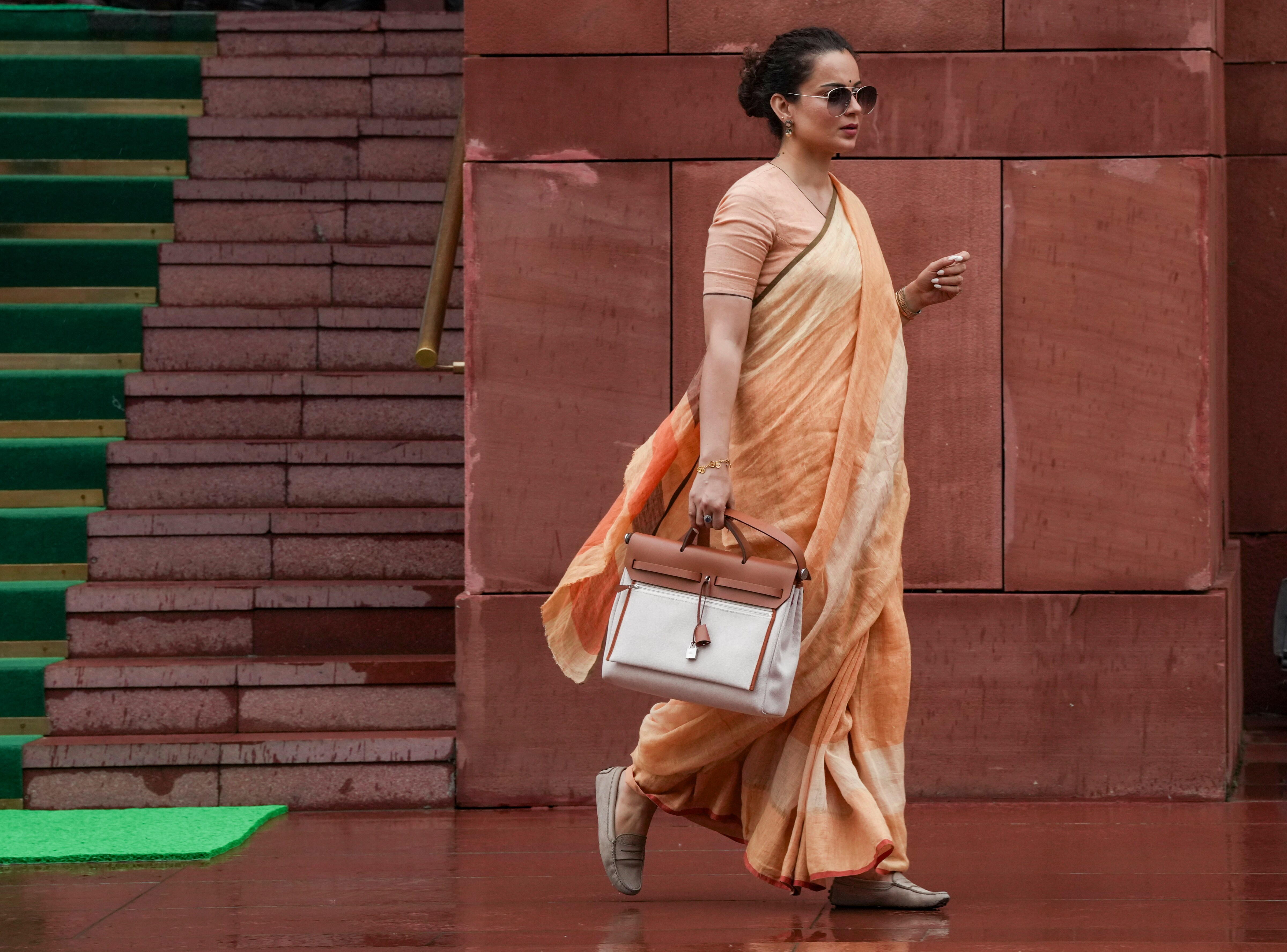 The Bollywood actor stepped into a session wearing muted earthy tones - a soft saffron-orange ensemble with delicate gold accents, paired with her signature Birkin. (Arun Sharma/PTI) The Bollywood actor stepped into a session wearing muted earthy tones - a soft saffron-orange ensemble with delicate gold accents, paired with her signature Birkin. (Arun Sharma/PTI)