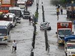 Vehicles wade through a waterlogged stretch after heavy rain on the National Highway-48 near Narsinghpur village, in Gurugram. Vehicles wade through a waterlogged stretch after heavy rain on the National Highway-48 near Narsinghpur village, in Gurugram.