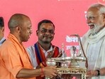 Chief minister Yogi Adityanath presents a handcrafted Shivling to Prime Minister Narendra Modi in Varanasi on Saturday. (ANI PHOTO) Chief minister Yogi Adityanath presents a handcrafted Shivling to Prime Minister Narendra Modi in Varanasi on Saturday. (ANI PHOTO)