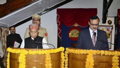 Governor Shiv Pratap Shukla administering the oath of office and secrecy to Pavnesh Kumar as member of the Himachal Pradesh Public Service Commission at Raj Bhavan in Shimla on Saturday. (Deepak Sansta/HT)