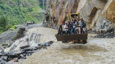 An excavator being used to assist people to cross a stream, in Lahaul and Spiti district of Himachal Pradesh, Friday. (PTI) An excavator being used to assist people to cross a stream, in Lahaul and Spiti district of Himachal Pradesh, Friday. (PTI)
