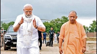 Prime Minister Narendra Modi and chief minister Yogi Adityanath upon the former’s arrival to address a public meeting, in Varanasi on Saturday. (PTI PHOTO) Prime Minister Narendra Modi and chief minister Yogi Adityanath upon the former’s arrival to address a public meeting, in Varanasi on Saturday. (PTI PHOTO)
