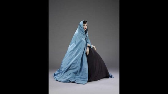 A 1957 full-fitting cape by Hubert de Givenchy. Made of silk taffeta, the cape is a replica of the one designed for Audrey Hepburn to wear in the film Funny Face (1957). (V&A East Storehouse)