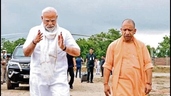 Prime Minister Narendra Modi and chief minister Yogi Adityanath upon the former’s arrival to address a public meeting, in Varanasi on Saturday. (PTI PHOTO)