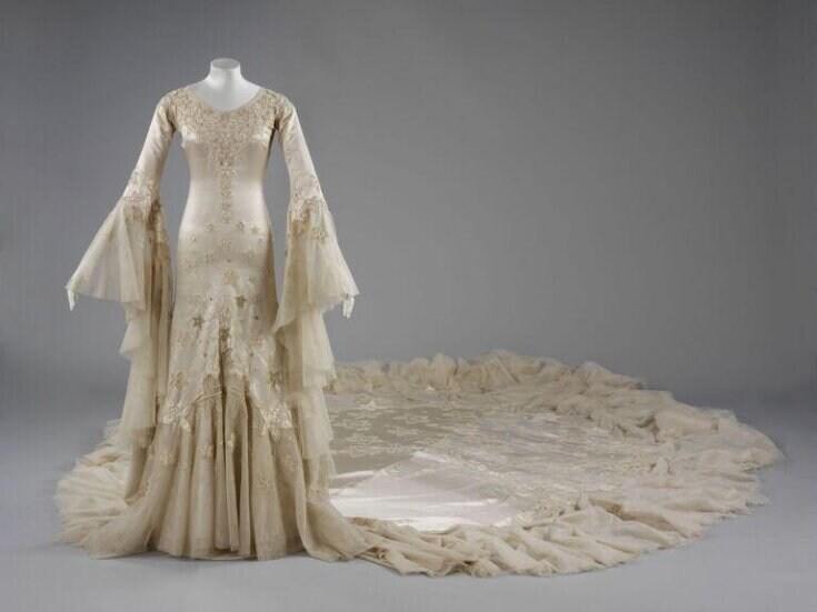 A wedding dress from 1933 by Norman Hartnell, featuring embroidered silk satin, pearls, glass beads, satin applique and tulle. (V&A East Storehouse)