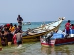Fishermen sit in boats near the Red Sea shore in the Khokha district on the southern edge of the Yemen's western Red Sea city of Hodeida on May 16, 2025.