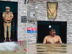 UP police officer Chandradeep Nishad offers prayers to floodwater outside his home in Prayagraj, calling it a blessing from ‘Mother Ganga’.