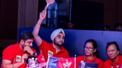 A team bids for a player during the DPL 2025 women's auction. 