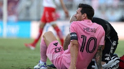 Trainers had to come and help an injured Lionel Messi, who was eventually subbed off in the 11th minute. (Getty Images via AFP) Trainers had to come and help an injured Lionel Messi, who was eventually subbed off in the 11th minute. (Getty Images via AFP)