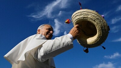 Pope Leo XIV holds a hat on the day of a Mass for Jubilee of Youth in Tor Vergata, in Rome, Italy, August 3, 2025.  Vatican Media/­Handout via REUTERS    ATTENTION EDITORS - THIS IMAGE WAS PROVIDED BY A THIRD PARTY.     TPX IMAGES OF THE DAY (via REUTERS)