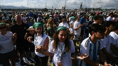 Young faithfuls hold hands during an open-air mass in the Tor Vergata district of Rome, as part of Jubilee of Youth, on August 3, 2025. (Photo by Filippo MONTEFORTE / AFP) (AFP) Young faithfuls hold hands during an open-air mass in the Tor Vergata district of Rome, as part of Jubilee of Youth, on August 3, 2025. (Photo by Filippo MONTEFORTE / AFP) (AFP)