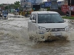 A car wades through a waterlogged road in Lucknow on Sunday. (Deepak Gupta/HT) A car wades through a waterlogged road in Lucknow on Sunday. (Deepak Gupta/HT)
