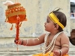 A child dressed as Lord Krishna tries to break an earthen pot (dahi handi) on the occasion of Janmashtami festival. (PTI File Photo)