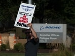 A worker pickets outside the Boeing Defense, Space & Security facility in Berkeley, Missouri, US, on Monday, Aug. 4, 2025.