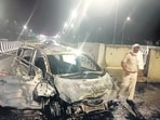 Burnt remains of the Ertiga taxi after the accident. (HT Photo)