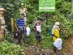 Workers leave from a site of an alleged burial related to the Dharmasthala mass burial case, at Dharmasthala, in Dakshina Kannada district, on Monday. (PTI) Workers leave from a site of an alleged burial related to the Dharmasthala mass burial case, at Dharmasthala, in Dakshina Kannada district, on Monday. (PTI)