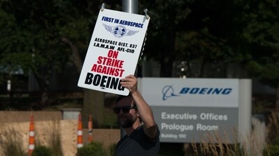 A worker pickets outside the Boeing Defense, Space & Security facility in Berkeley, Missouri, US, on Monday, Aug. 4, 2025. (Bloomberg) A worker pickets outside the Boeing Defense, Space & Security facility in Berkeley, Missouri, US, on Monday, Aug. 4, 2025. (Bloomberg)