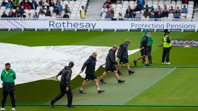 Groundstaff cover the pitch during a downpour at the Oval. (PTI) Groundstaff cover the pitch during a downpour at the Oval. (PTI)