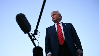 US President Donald Trump speaks to journalists at Lehigh Valley International Airport in Allentown, Pennsylvania, as he returns to the White House from his Bedminster residence, where he spent the weekend. (AFP)