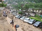 People commute through a muddy road following a flash flood in Mandi, Himachal Pradesh. (ANI) People commute through a muddy road following a flash flood in Mandi, Himachal Pradesh. (ANI)