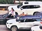 Two other men are seen recording videos, while other members of the group cheered from adjoining vehicles, some of them standing on footrests and others coming out of the sunroofs. The cars had illegally installed sirens, which were blared continuously, the residents alleged. (HT PHOTO) Two other men are seen recording videos, while other members of the group cheered from adjoining vehicles, some of them standing on footrests and others coming out of the sunroofs. The cars had illegally installed sirens, which were blared continuously, the residents alleged. (HT PHOTO)