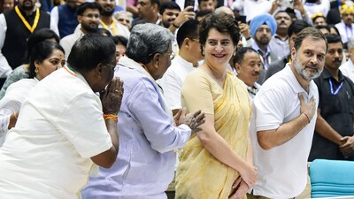 Congress leader Rahul Gandhi greets party leaders as his sister and fellow MP Priyanka Gandhi Vadra looks on, at a conclave in Delhi. (PTI File)