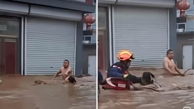 Rescuers helping a couple during a flood in China. (Screengrab (Rednote)) Rescuers helping a couple during a flood in China. (Screengrab (Rednote))