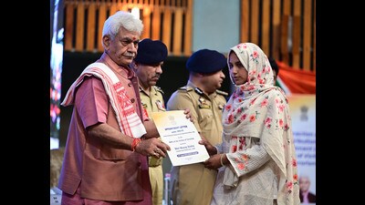 J&K LG Manoj Sinha hands over a job letter to family member of terror victim in Srinagar on Tuesday. (Waseem Andrabi /HT) J&K LG Manoj Sinha hands over a job letter to family member of terror victim in Srinagar on Tuesday. (Waseem Andrabi /HT)
