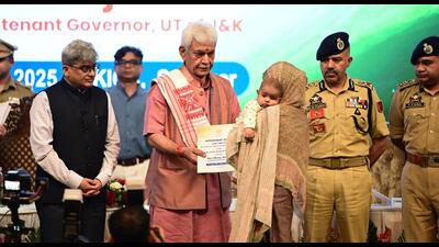 Jammu and Kashmir lieutenant governor Manoj Sinha handing over a job appointment letter to a family member of a terror victim in Srinagar on Tuesday. (Waseem Andrabi/HT) Jammu and Kashmir lieutenant governor Manoj Sinha handing over a job appointment letter to a family member of a terror victim in Srinagar on Tuesday. (Waseem Andrabi/HT)