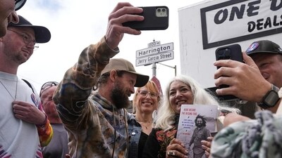 Trixie Garcia, second from right, poses for selfies with a Grateful Dead fans, following the unveiling of Jerry Garcia Street in San Francisco, on Aug. 1, Trixie Garcia, second from right, poses for selfies with a Grateful Dead fans, following the unveiling of Jerry Garcia Street in San Francisco, on Aug. 1,