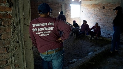 Members of the search collective "Hasta Encontrarte" gather at the property where the bodies of 32 people were found in a clandestine grave in the community of La Calera in Guanajuato. (AFP) Members of the search collective "Hasta Encontrarte" gather at the property where the bodies of 32 people were found in a clandestine grave in the community of La Calera in Guanajuato. (AFP)