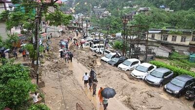 People commute through a muddy road following a flash flood in Mandi, Himachal Pradesh. (ANI) People commute through a muddy road following a flash flood in Mandi, Himachal Pradesh. (ANI)