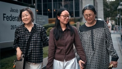 Yeonsoo Go (C), a 20-year-old South Korean student attending Purdue University, reunites with her mother, Episcopal priest the Rev. Kyrie Kim (R), after being released by U.S. Immigration and Customs Enforcement (ICE) on August 4, 2025 in New York City. (Getty Images via AFP)