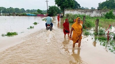 People were seen commuting on foot through flooded areas in several districts of Uttar Pradesh after heavy rainfall triggered floods. (Rajesh Kumar/ANI) People were seen commuting on foot through flooded areas in several districts of Uttar Pradesh after heavy rainfall triggered floods. (Rajesh Kumar/ANI)