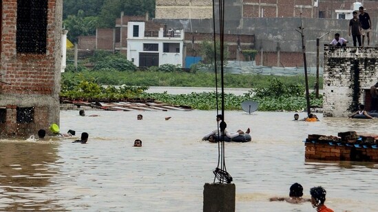 Many areas witnessed waterlogging and flood-like situation, with people seen taking a dip in following heavy rainfall in Uttar Pradesh(PTI)