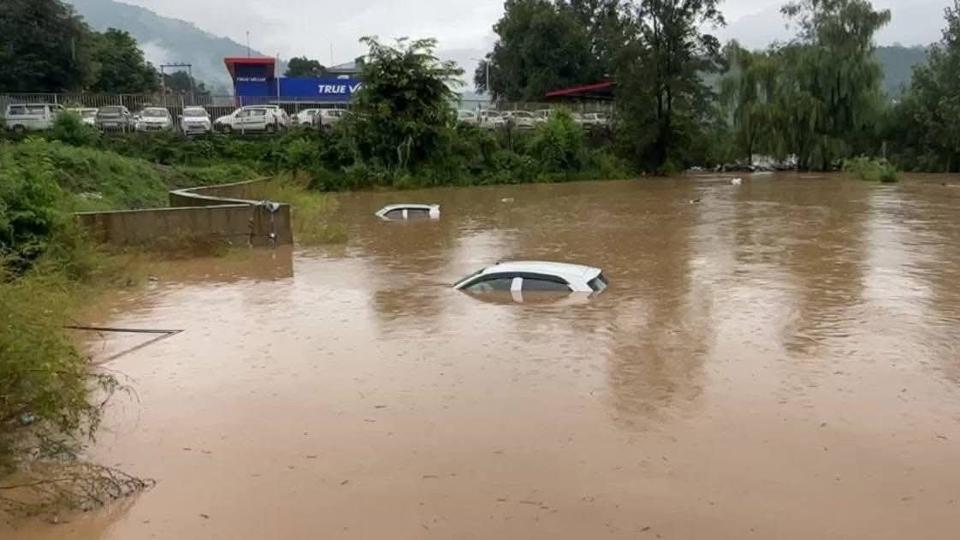Vehicles submerged after the water level of Suketi Khud rose due to continuous rain at Gutker in Mandi district on Tuesday. (HT Photo)