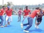 Indian men’s hockey team chief coach Craig Fulton tries his hand at raiding as his side met members of PKL team Gujarat Giants in Bengaluru on Wednesday. (HT)